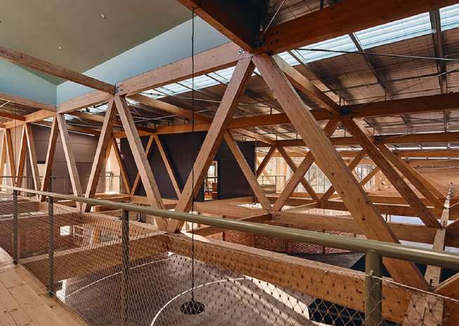 Repeating glulam timber trusses inside a GCE-engineered structure